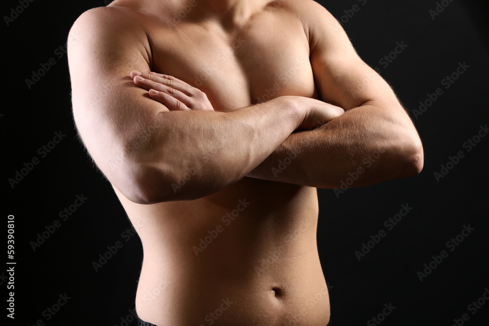 Handsome young muscular sportsman, on dark background Handsome young muscular sportsman, on dark background