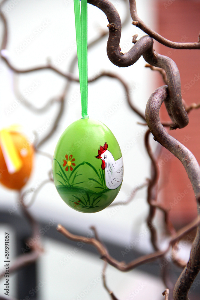 Handmade easter colored eggs hanging on the tree