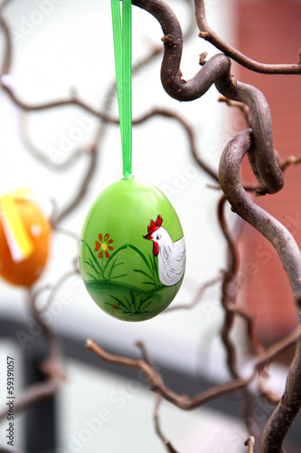Handmade easter colored eggs hanging on the tree