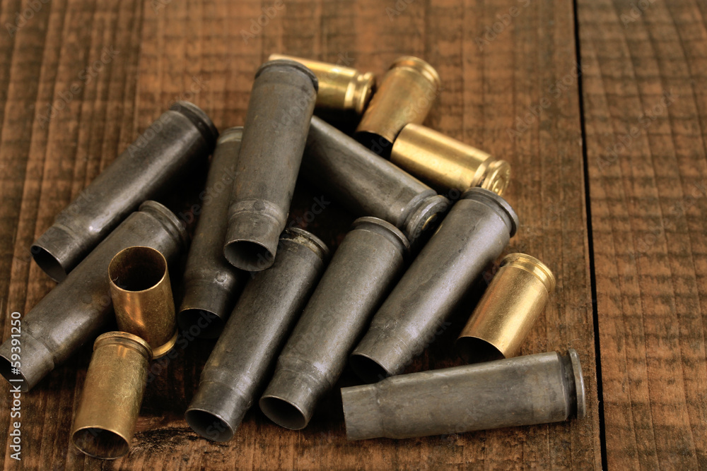 Shotgun cartridges on wooden table close-up Shotgun cartridges on wooden table close-up