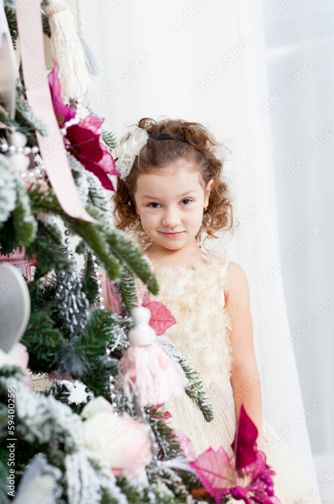 little girl decorates a Christmas Christmas tree little girl decorates a Christmas Christmas tree