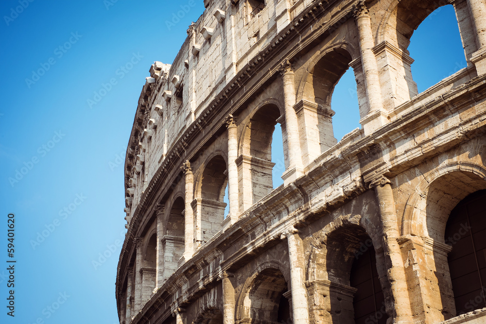 Detail of the Coliseum against the blue sky. Italy