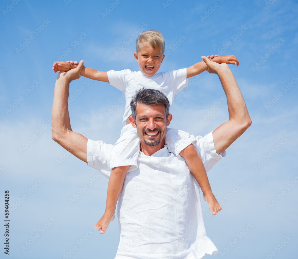 Father and son having fun on the beach Father and son having fun on the beach