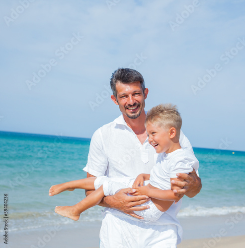 Father and son having fun on the beach