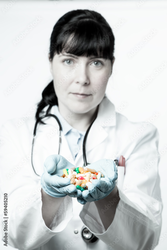 Doctor or pharmacist holding a pills in the hand Doctor or pharmacist holding a pills in the hand