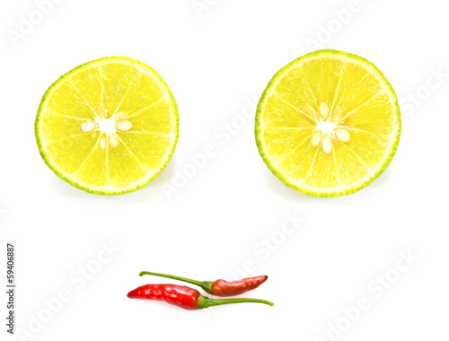 Limes and chilli peppers like a smiley face, isolated on white