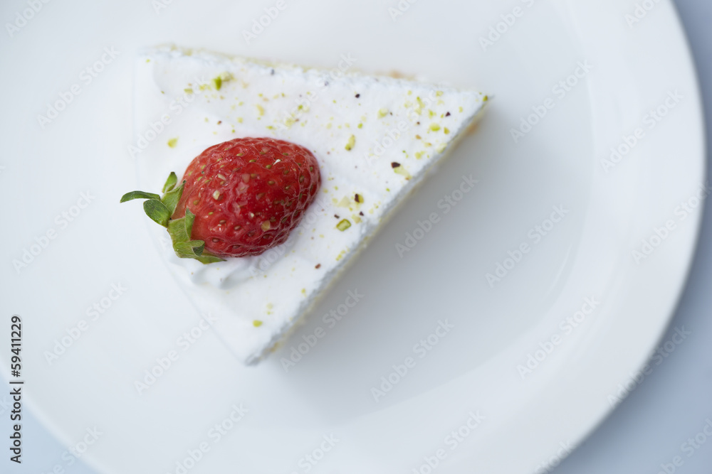 Piece of cake on white plate with strawberries Piece of cake on white plate with strawberries