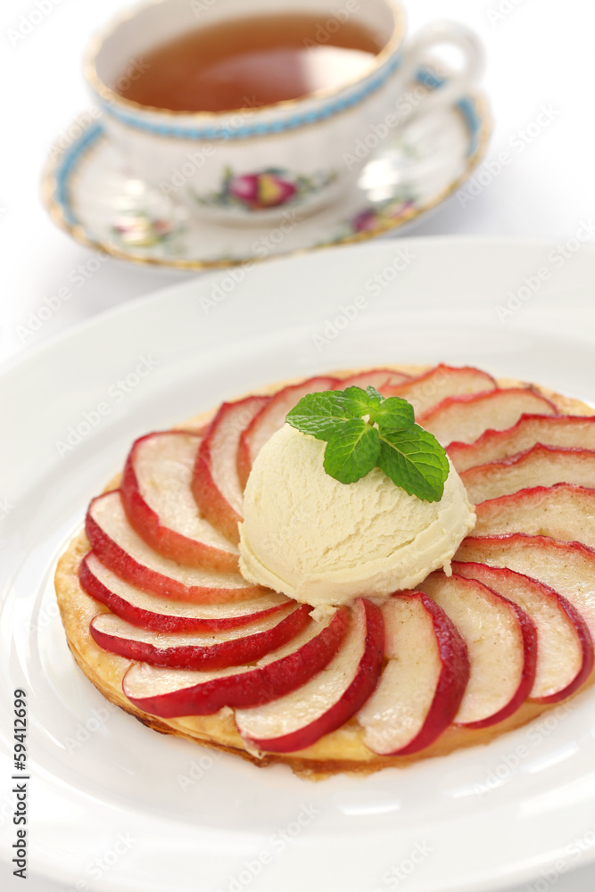french apple tart with ice cream and a cup of tea