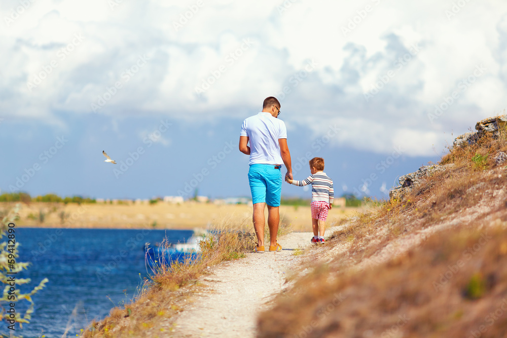 father and son walking on the cliff, seaside