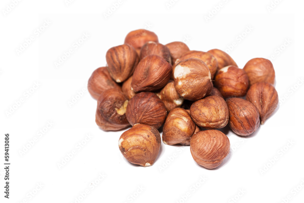 Brown hazelnuts against white background Brown hazelnuts against white background