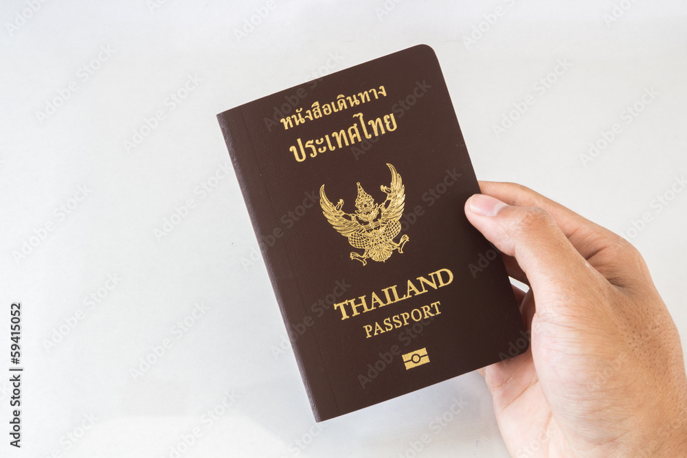 Hand holding an Thailand passport isolated on white background Hand holding an Thailand passport isolated on white background