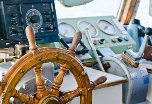 Steering wheel of an old sailing vessel, close up © Igor Sokolov