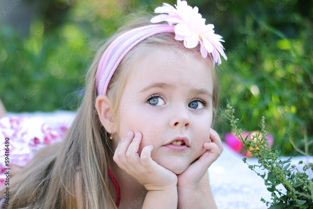 pretty little girl on green grass pretty little girl on green grass