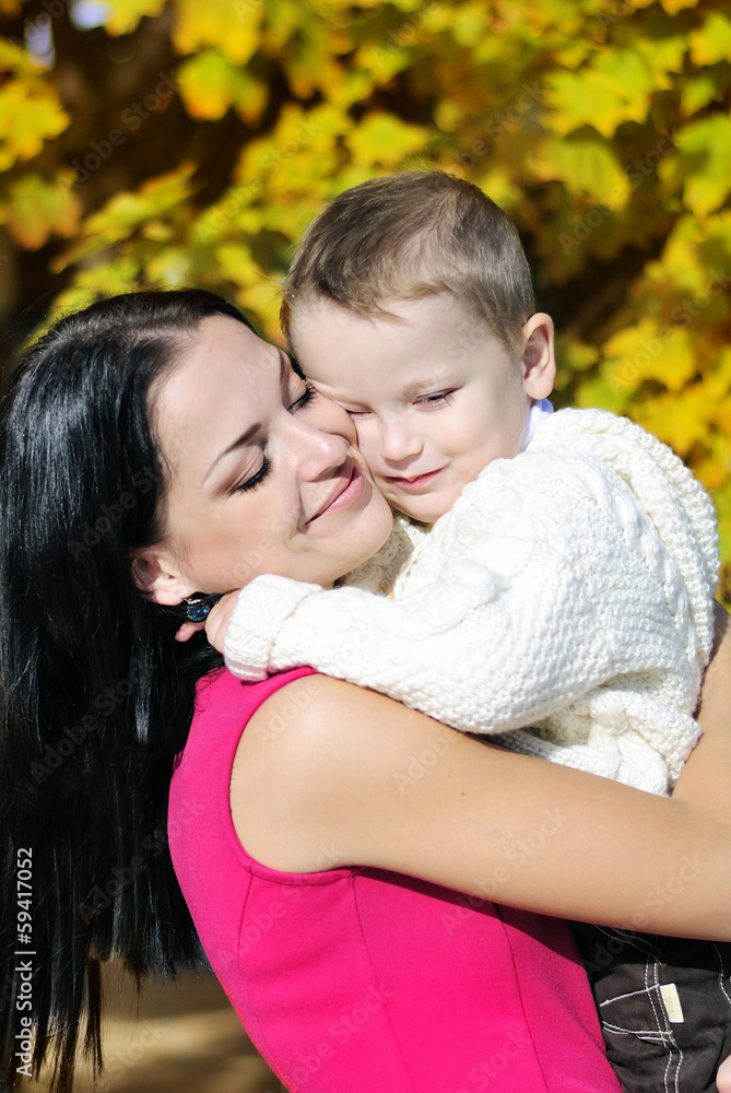 little boy with his mother in autumn park