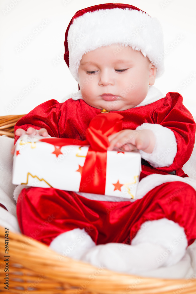 little santa baby with christmas hat lying in basket little santa baby with christmas hat lying in basket