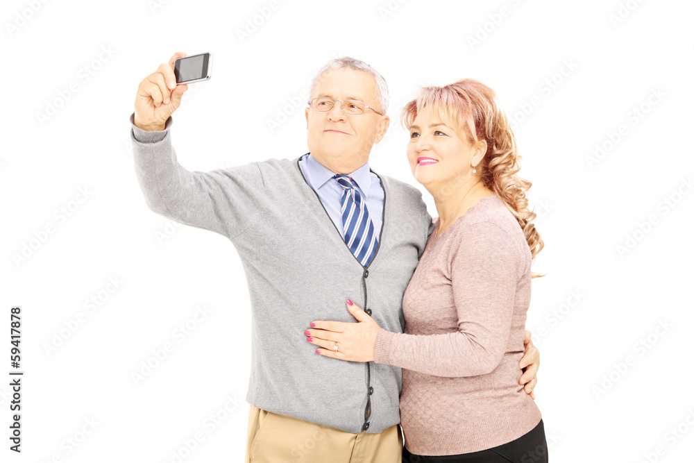 Happy mature man and woman taking pictures with phone Happy mature man and woman taking pictures with phone