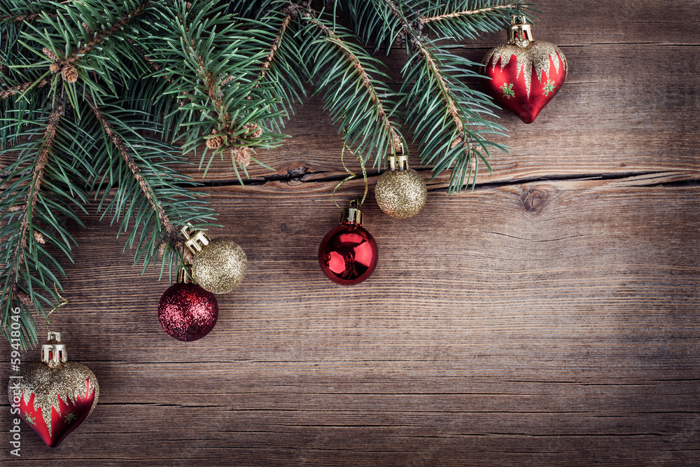 Fototapeta premium Christmas green fir tree with toys on a wooden board.