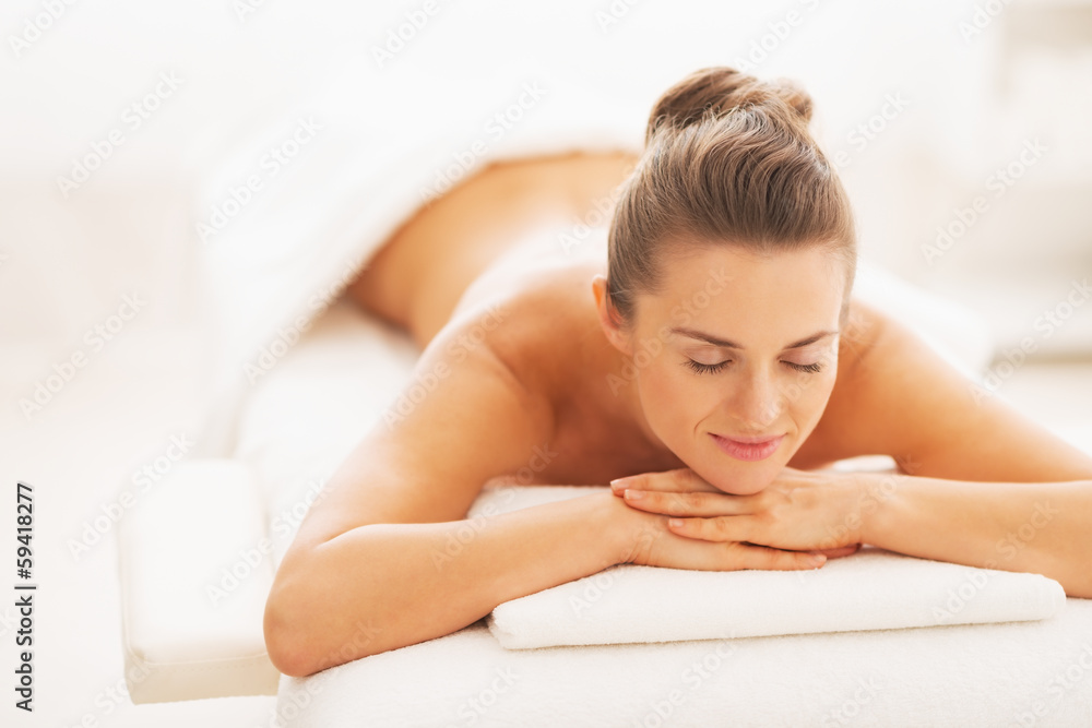 Portrait of happy young woman laying on massage table Portrait of happy young woman laying on massage table