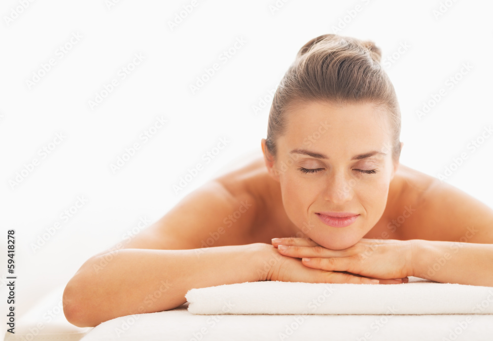 Portrait of relaxed young woman laying on massage table