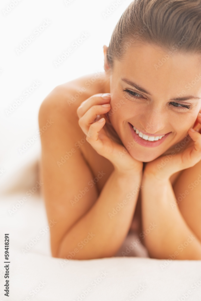 Portrait of happy young woman on massage table Portrait of happy young woman on massage table