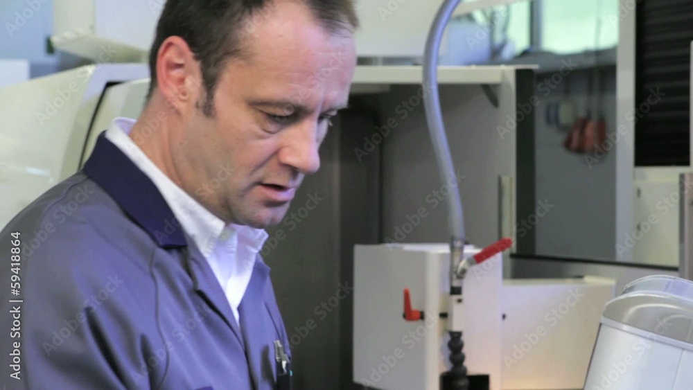 technician operates CNC Center at tool workshop technician operates CNC Center at tool workshop
