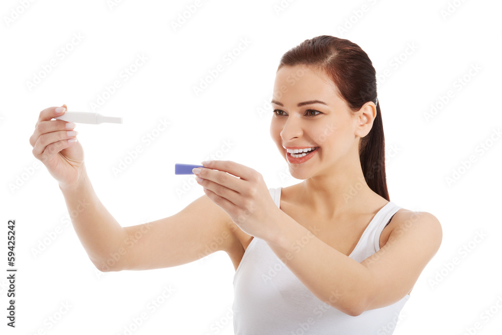 Happy beautiful young woman with pregnancy test. Happy beautiful young woman with pregnancy test.