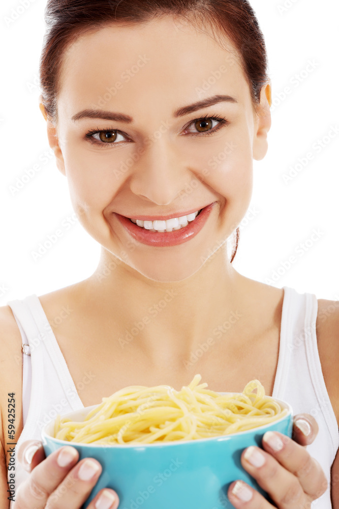 Beautiful young woman holding a bowl with raw pasta. Beautiful young woman holding a bowl with raw pasta.