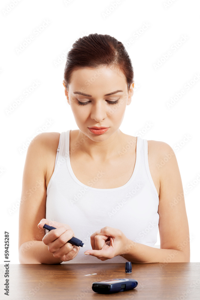 Beautiul young woman taking sugar level test. Beautiul young woman taking sugar level test.