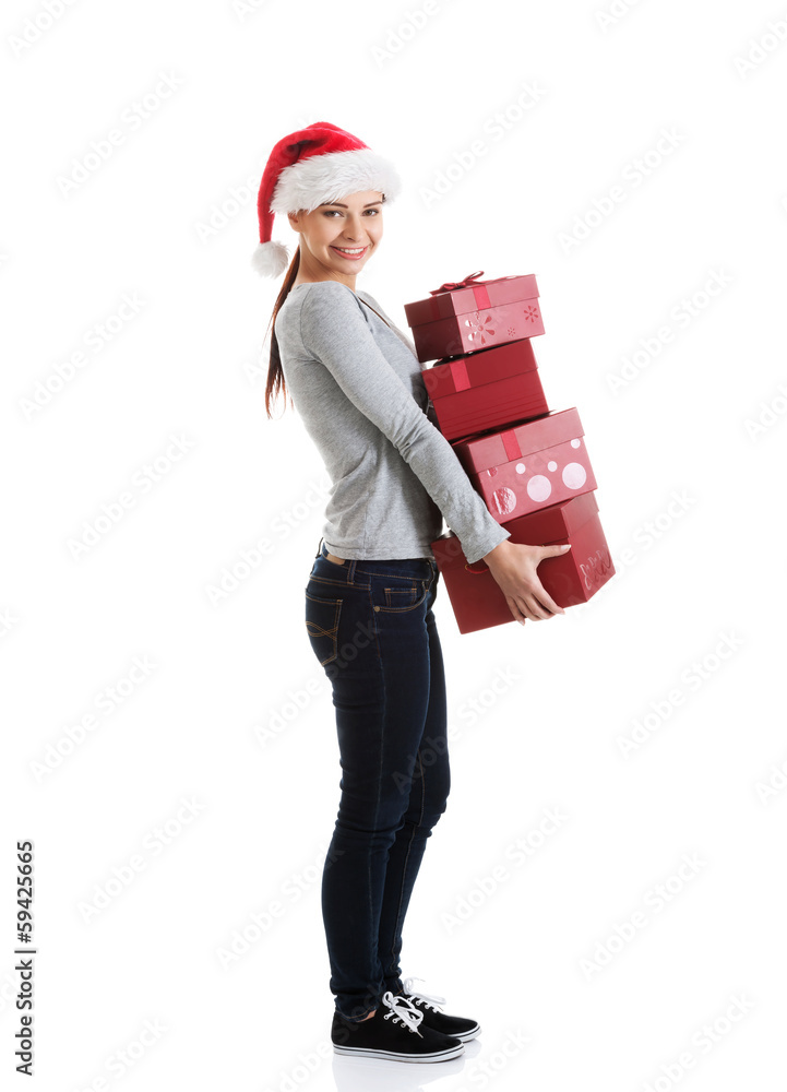 Beautiful young woman in santa hat with presents. Beautiful young woman in santa hat with presents.