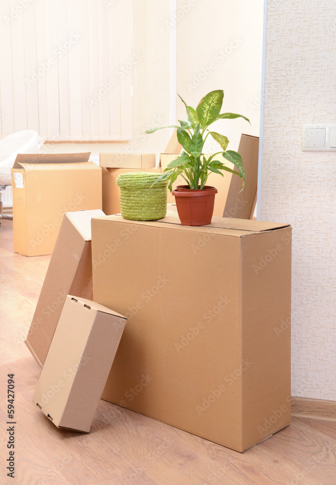 Empty room with stack of cartons: moving house concept Empty room with stack of cartons: moving house concept