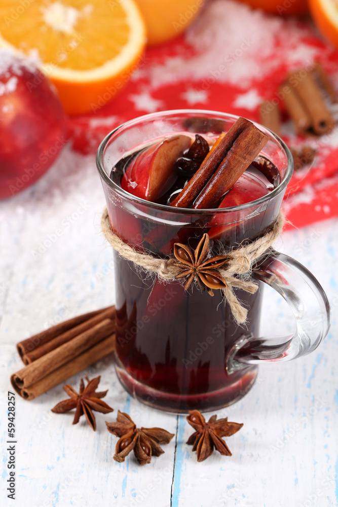 Fragrant mulled wine in glass on snow close-up Fragrant mulled wine in glass on snow close-up