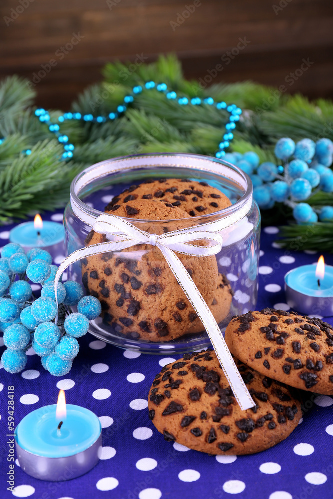 Delicious Christmas cookies in jar on table on wooden Delicious Christmas cookies in jar on table on wooden