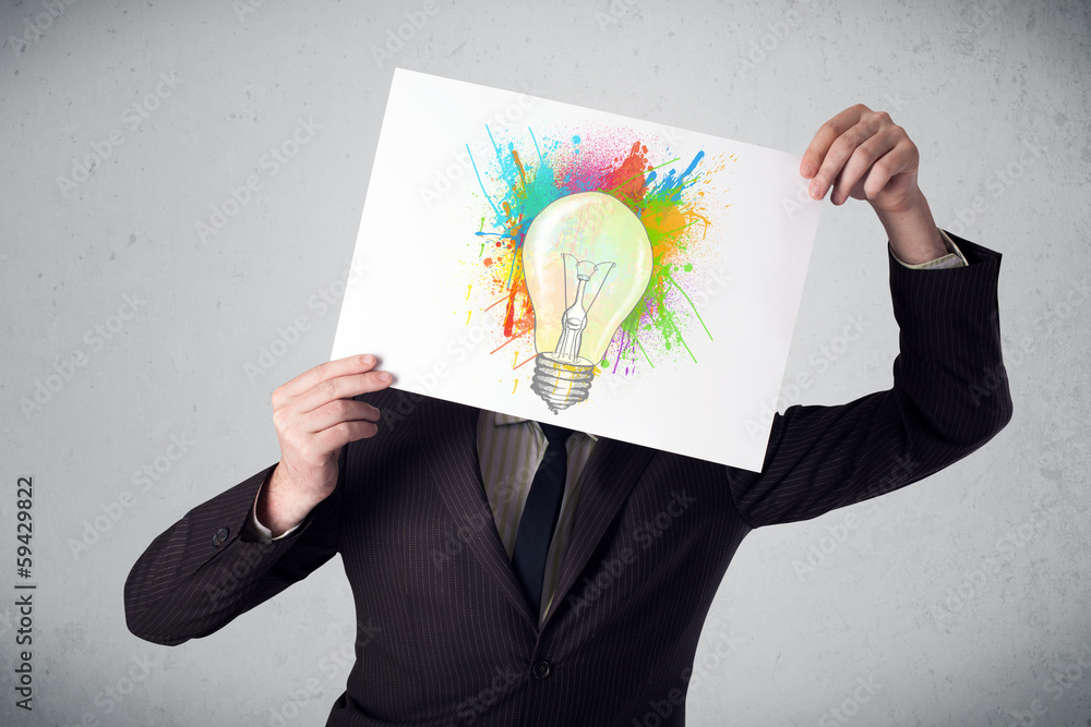 Businessman holding a cardboard with paint splashes and lightbul Businessman holding a cardboard with paint splashes and lightbul