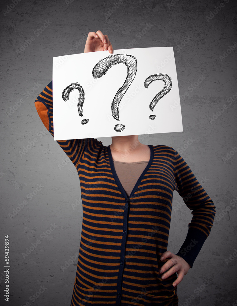 Woman holding paper with drawed question marks in front of her h Woman holding paper with drawed question marks in front of her h
