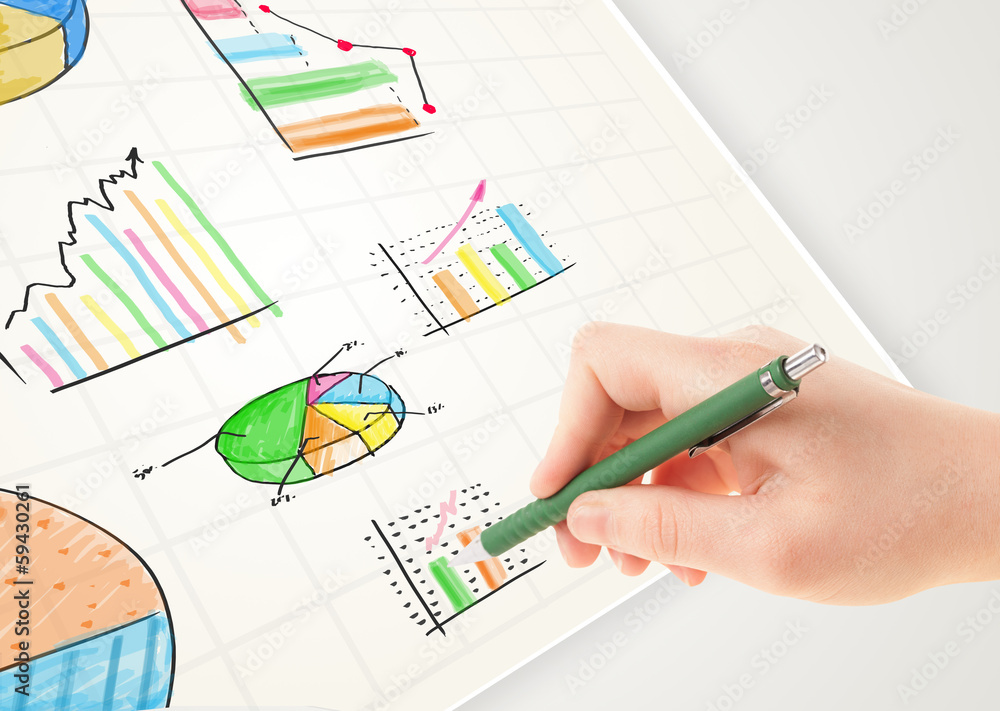 Business person drawing colorful graphs and icons on paper Business person drawing colorful graphs and icons on paper