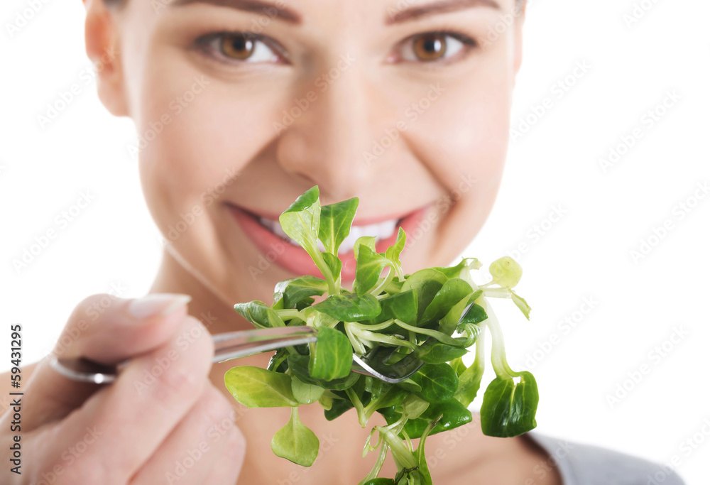 Beautiful woman eating lettuce.