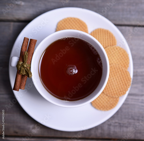 Cookies and cup of tea on wooden background