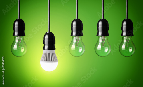 Photos Glowing LED bulb and simple light bulbs