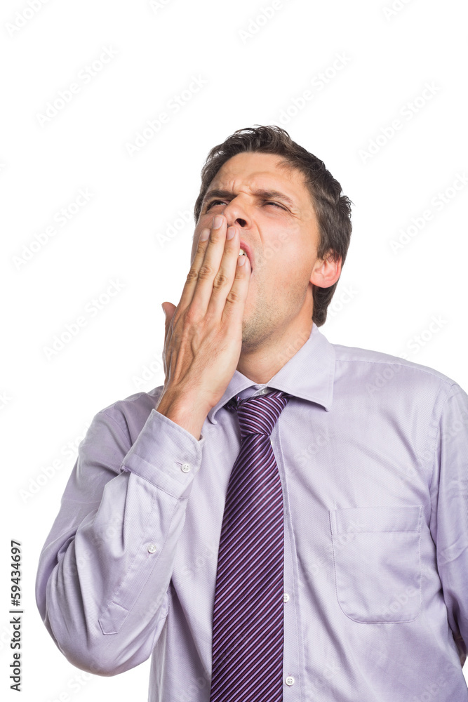 Young businessman in shirt and tie yawning Young businessman in shirt and tie yawning
