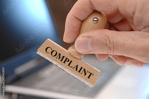 Foto complaint marked on rubber stamp in hand