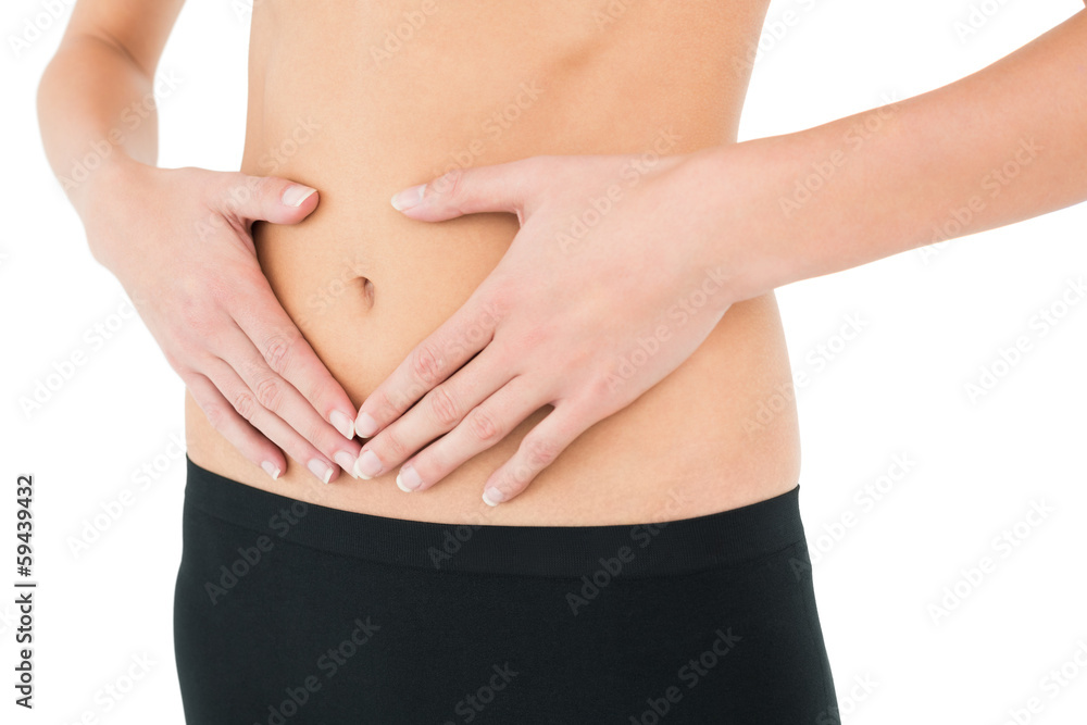 Close-up mid section of a fit woman in black shorts Close-up mid section of a fit woman in black shorts