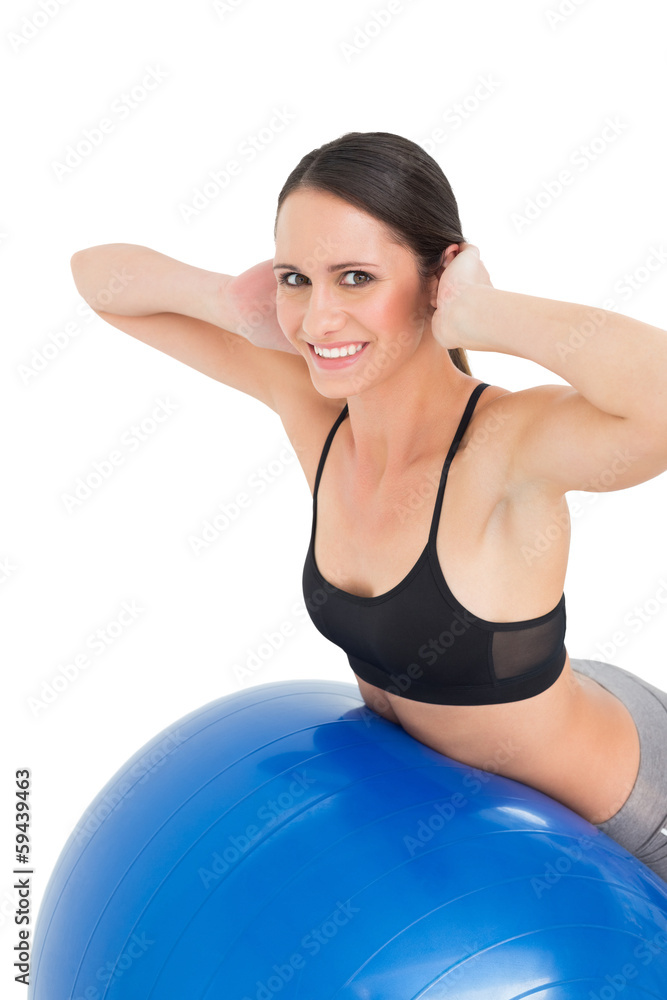 Side view portrait of a fit woman stretching on fitness ball Side view portrait of a fit woman stretching on fitness ball