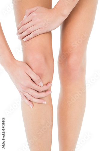 Close-up mid section of a young woman with knee pain