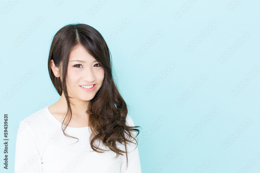 attractive asian woman on blue background attractive asian woman on blue background
