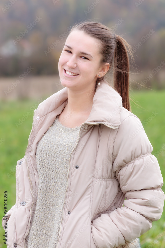 Teenage girl standing on the meadow