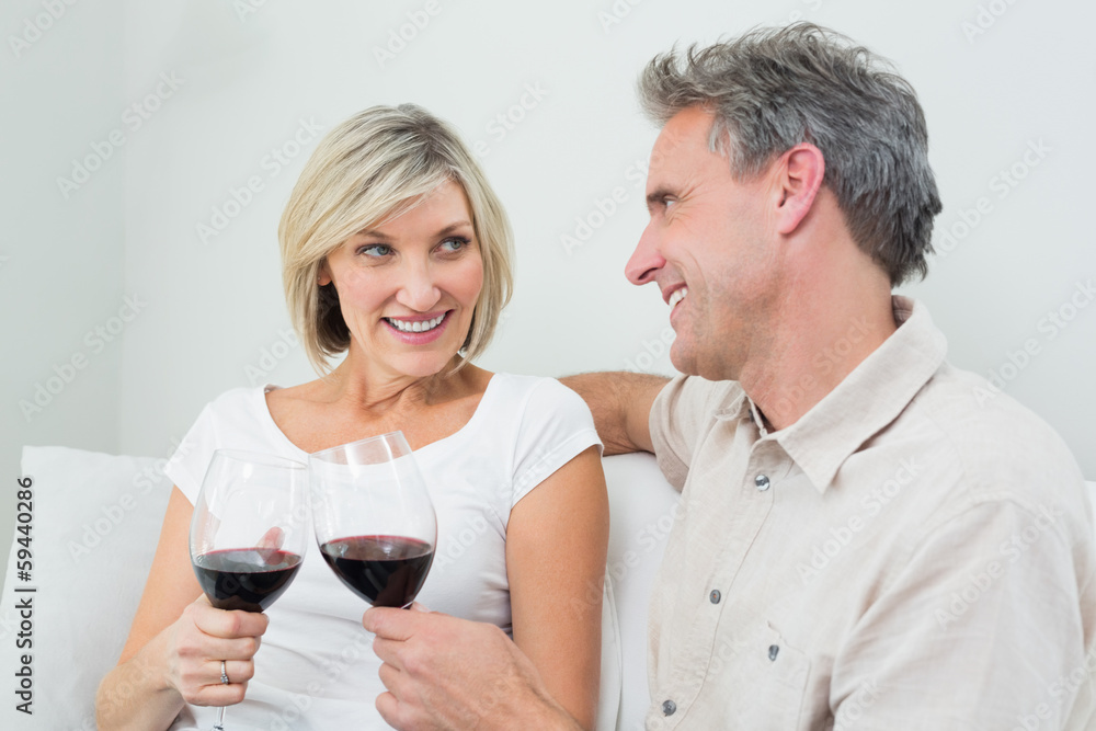 Couple toasting wine glasses at home Couple toasting wine glasses at home