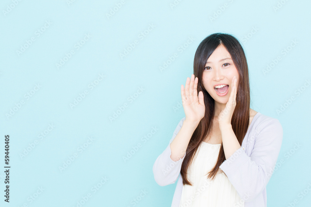 young asian woman calling on blue background young asian woman calling on blue background