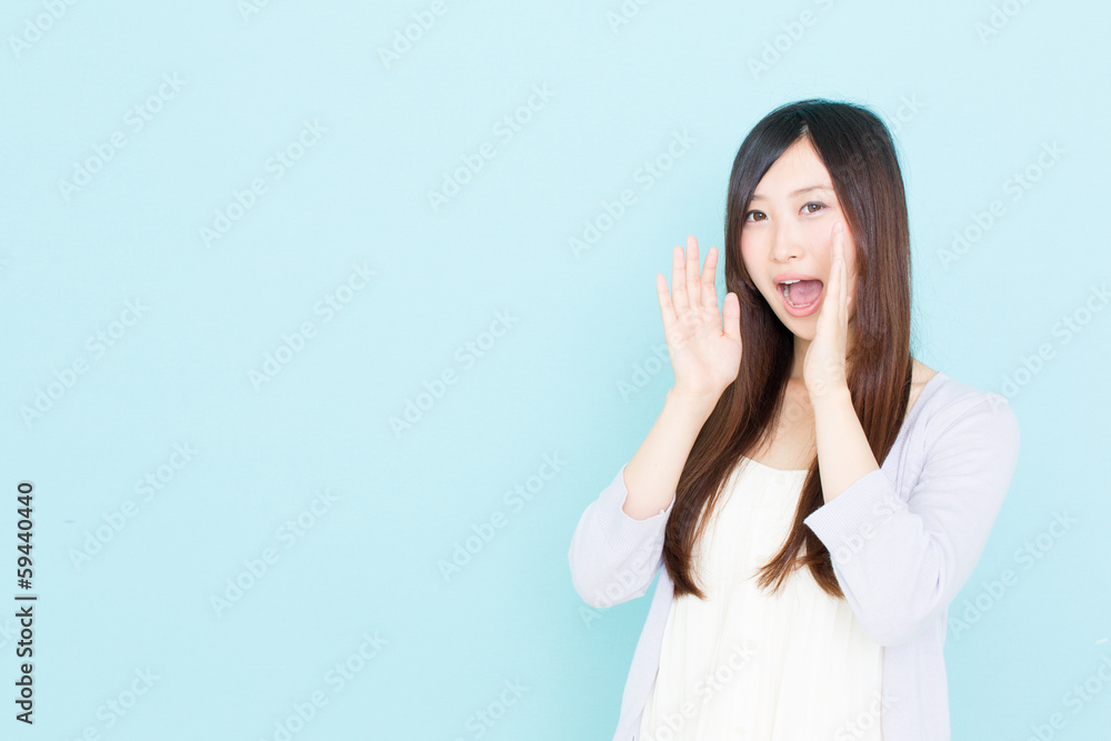 young asian woman calling on blue background young asian woman calling on blue background