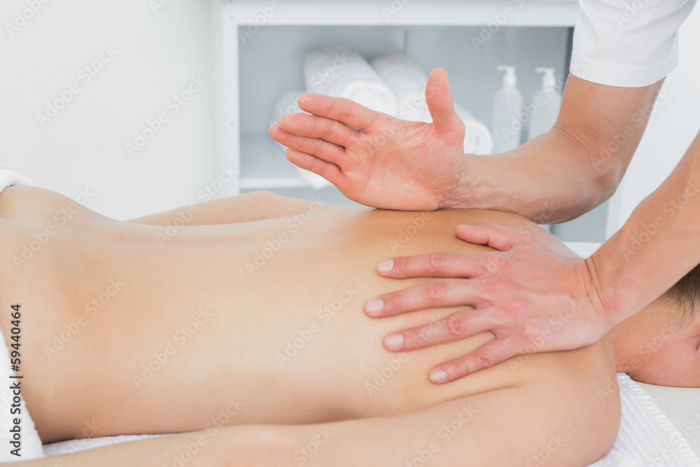 Close-up of a physiotherapist massaging woman's back Close-up of a physiotherapist massaging woman's back