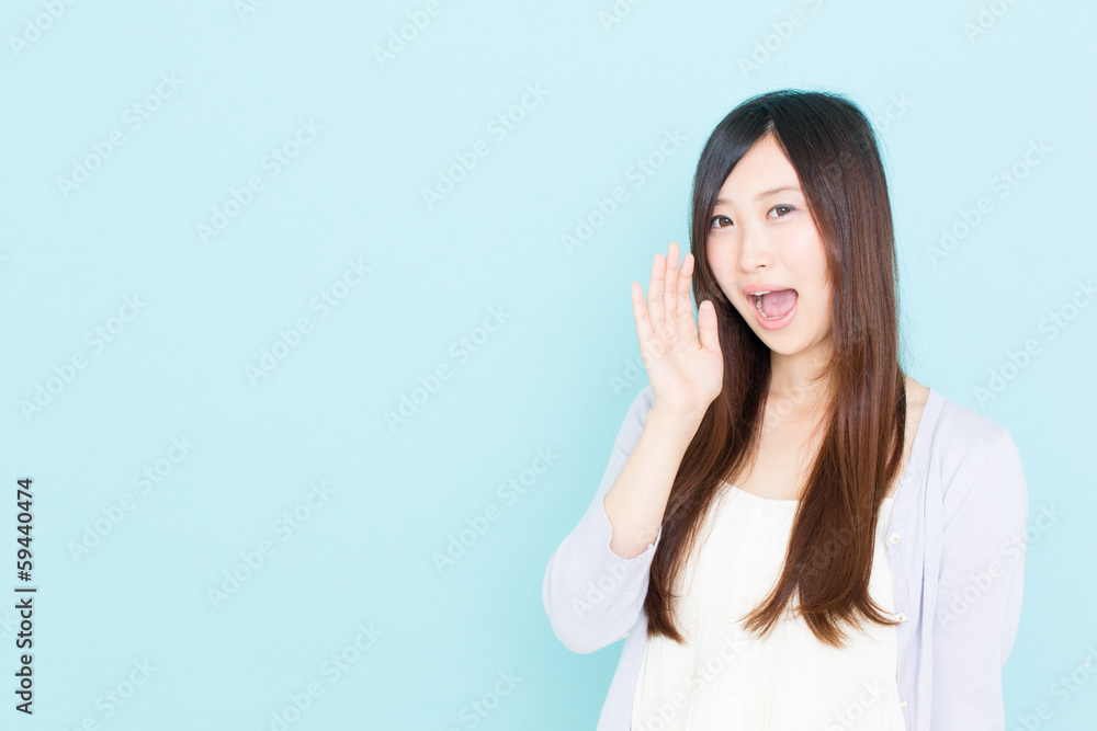 young asian woman calling on blue background young asian woman calling on blue background